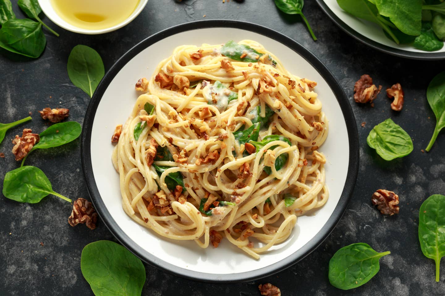 Pasta with roasted walnut, ricotta white pesto sauce, parmesan cheese and spinach