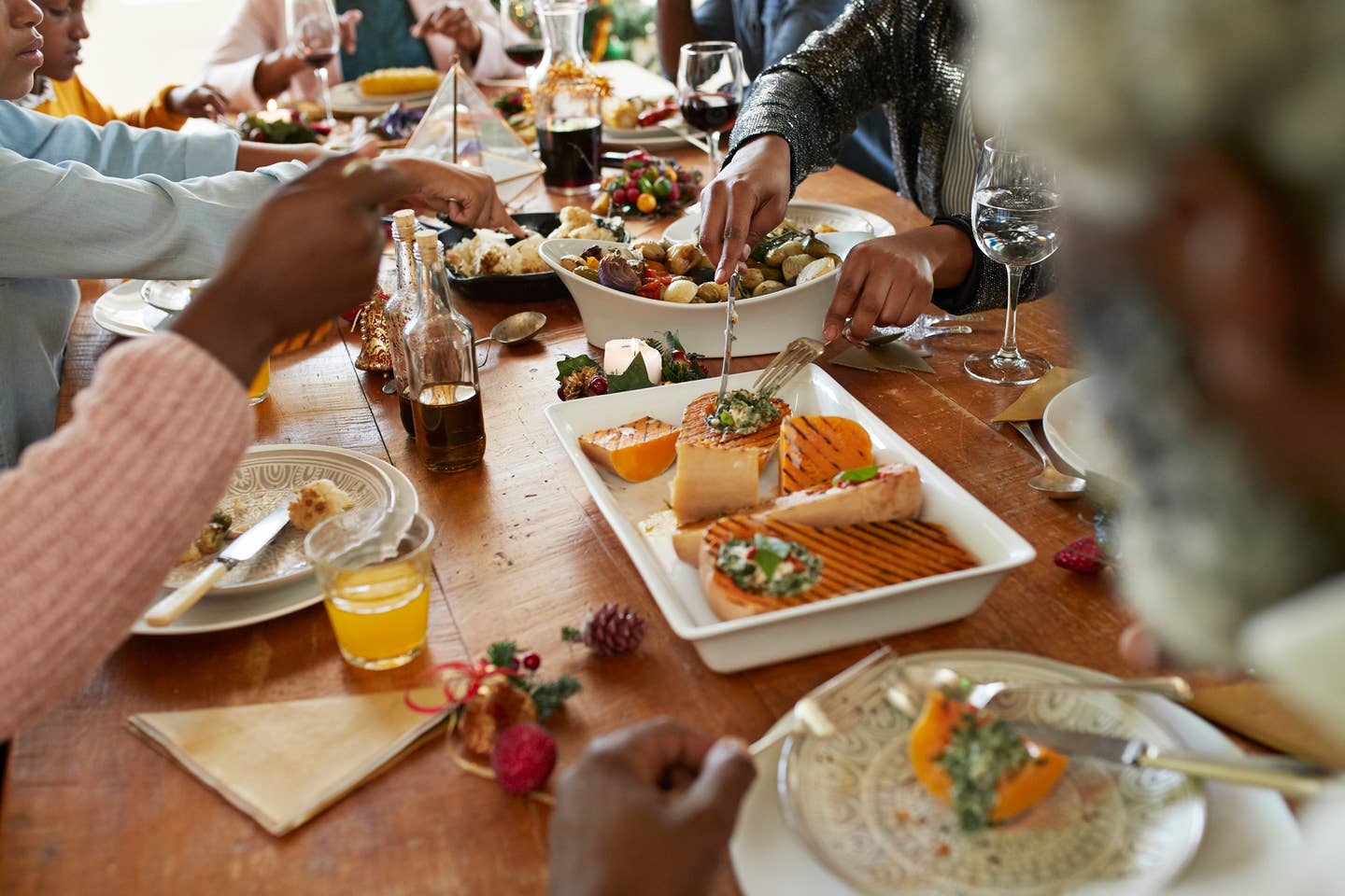 Woman serving appetizer to friends and family