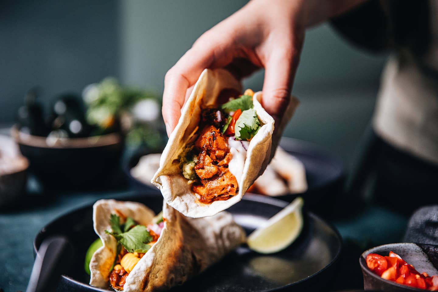 Woman serving vegan tacos