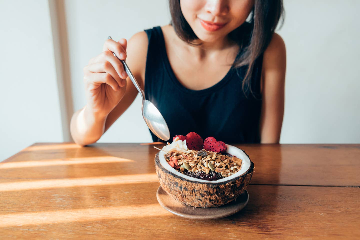 Cropped Shot Of Woman Eating Superfood Smoothie Bowl