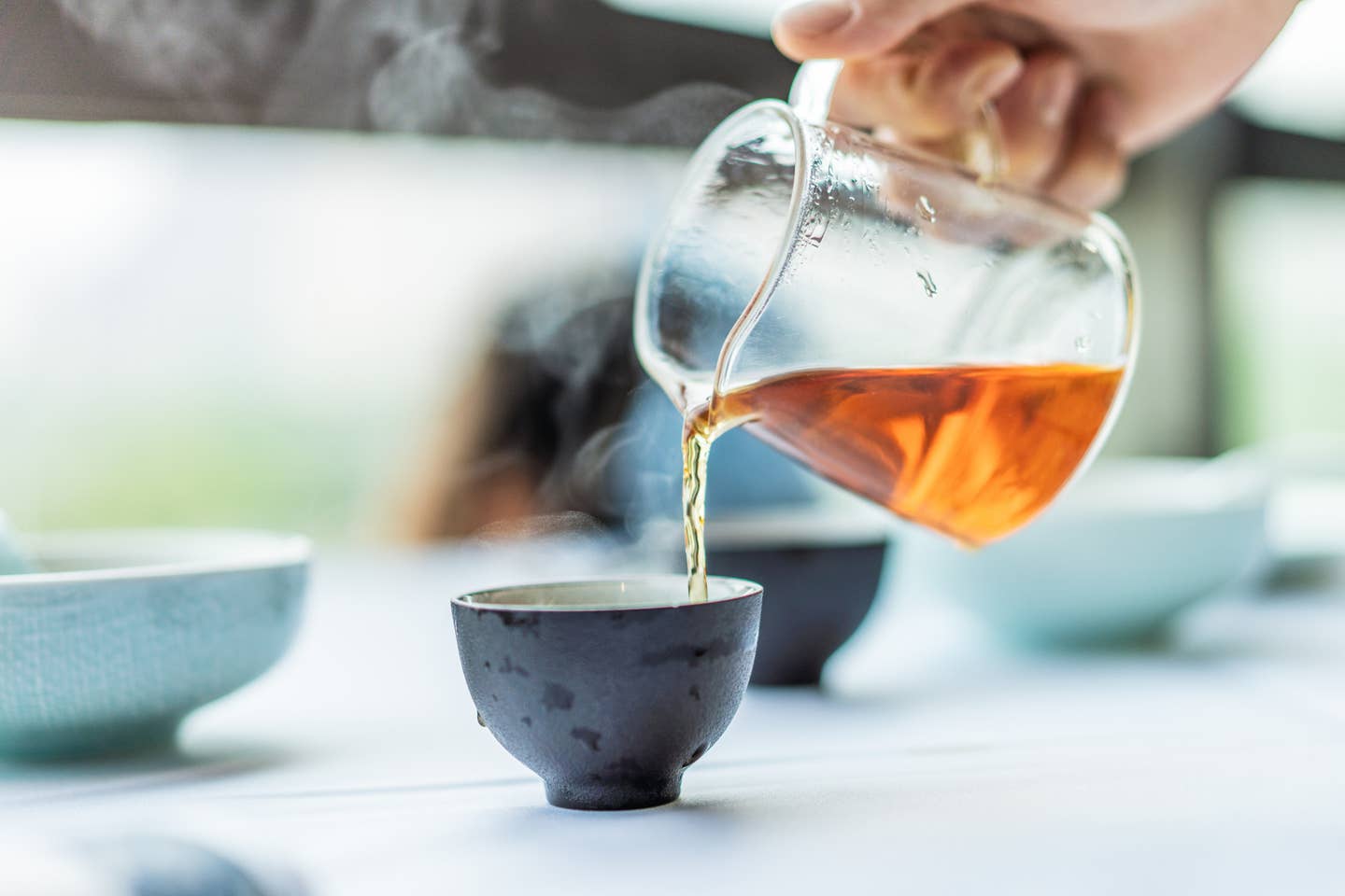 close-up of human hands serving chinese tea