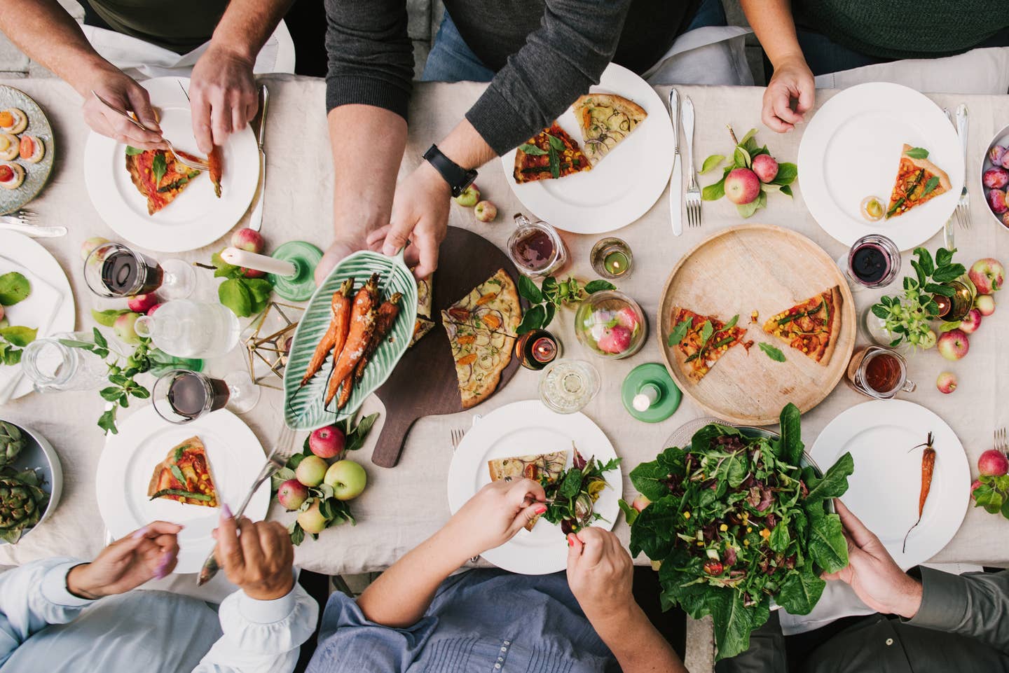 Friends enjoying a dinner together in greenhouse harvest party