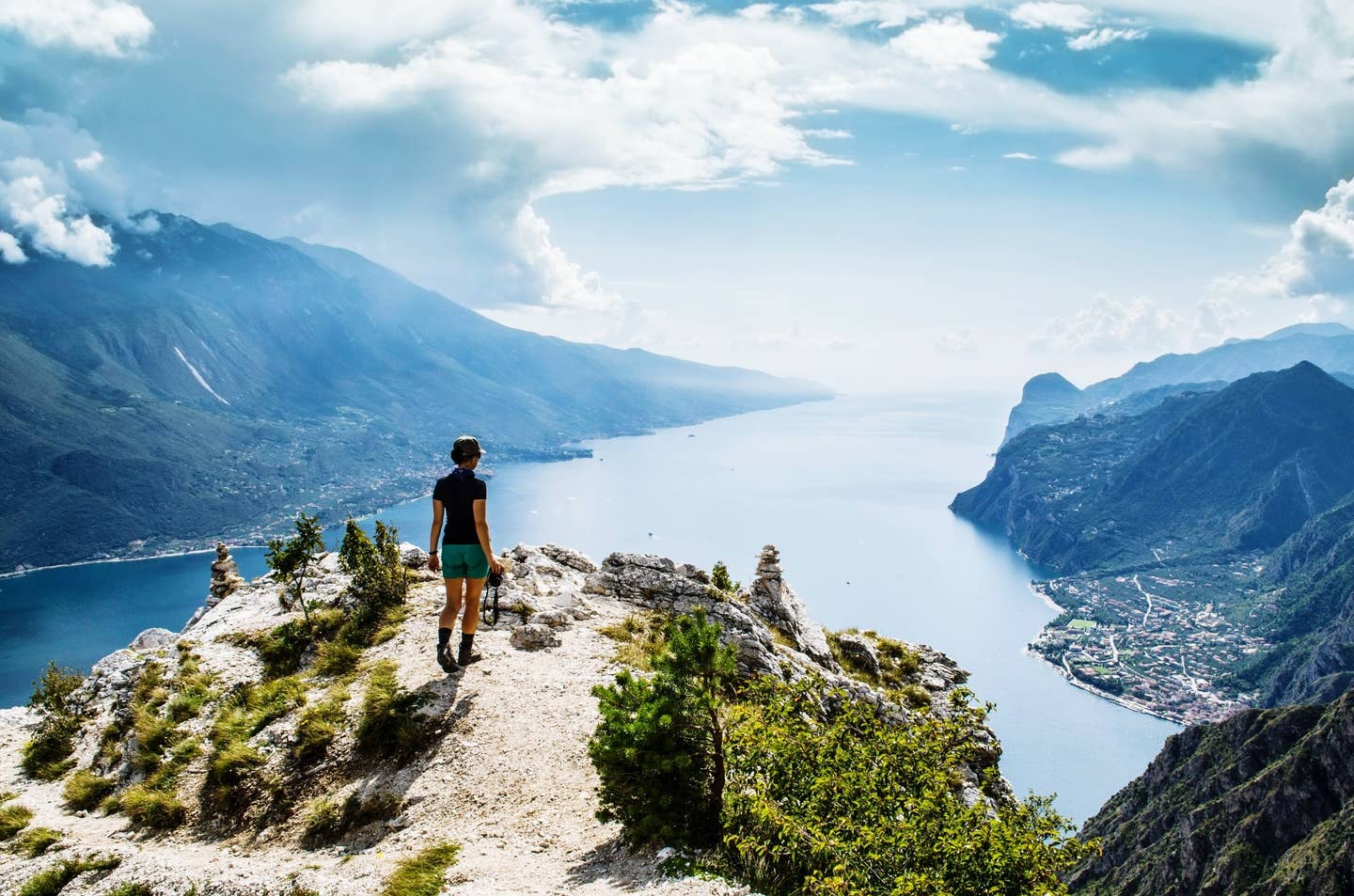 Rear View Of Mature Woman Looking At Lake While Standing On Mountain Against Sky