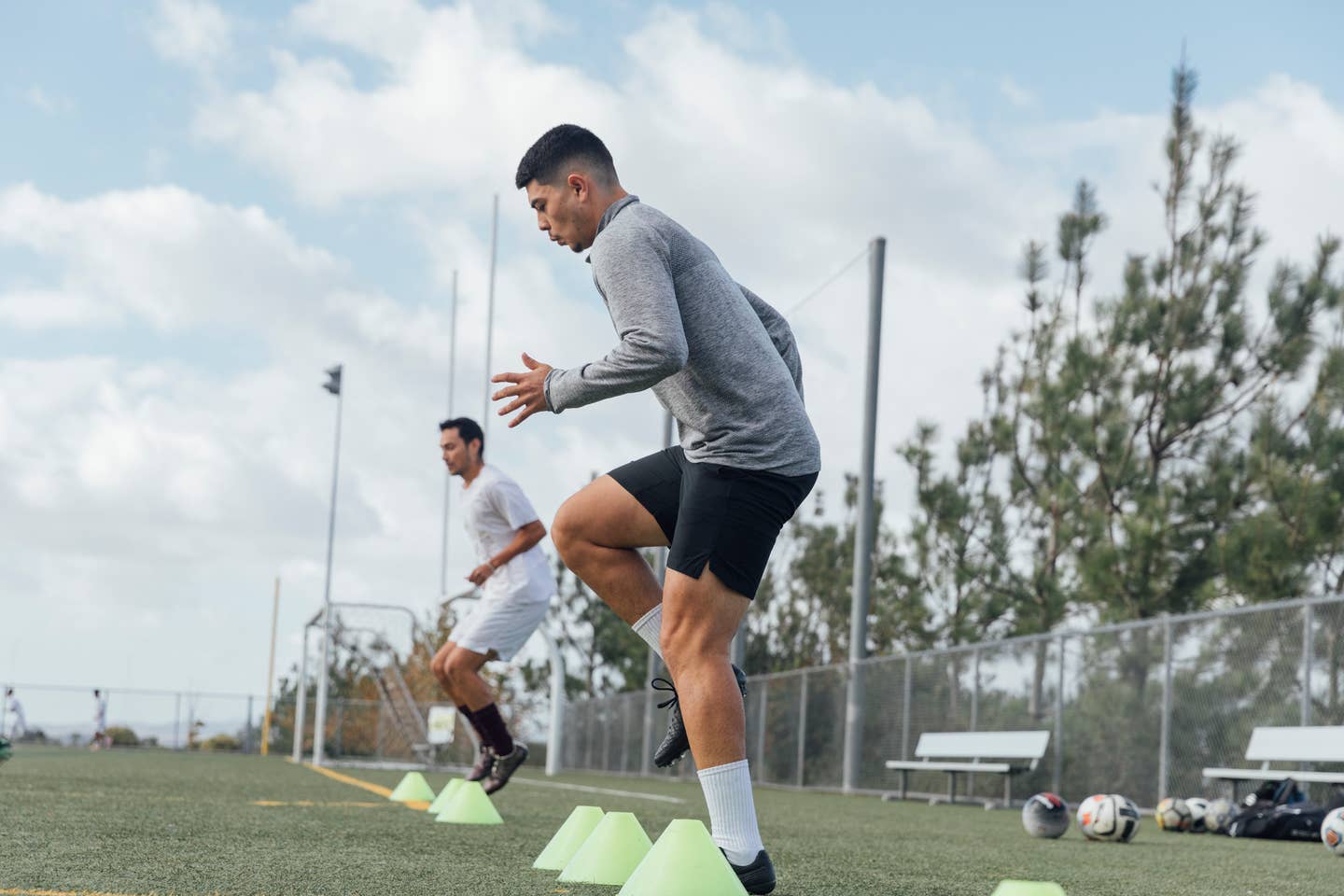 Soccer players performing warm up drills on field