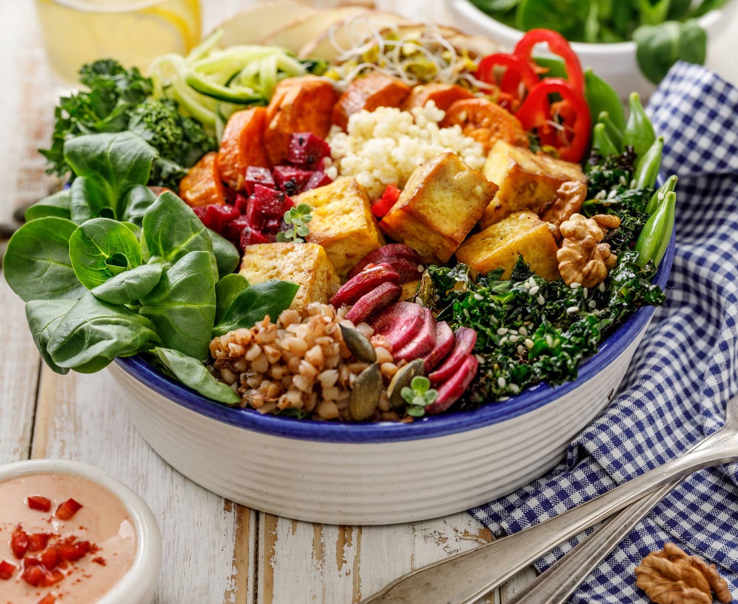 Buddha bowl of mixed vegetables,tofu cheese and groats. Healthy and nutritious vegan meal.