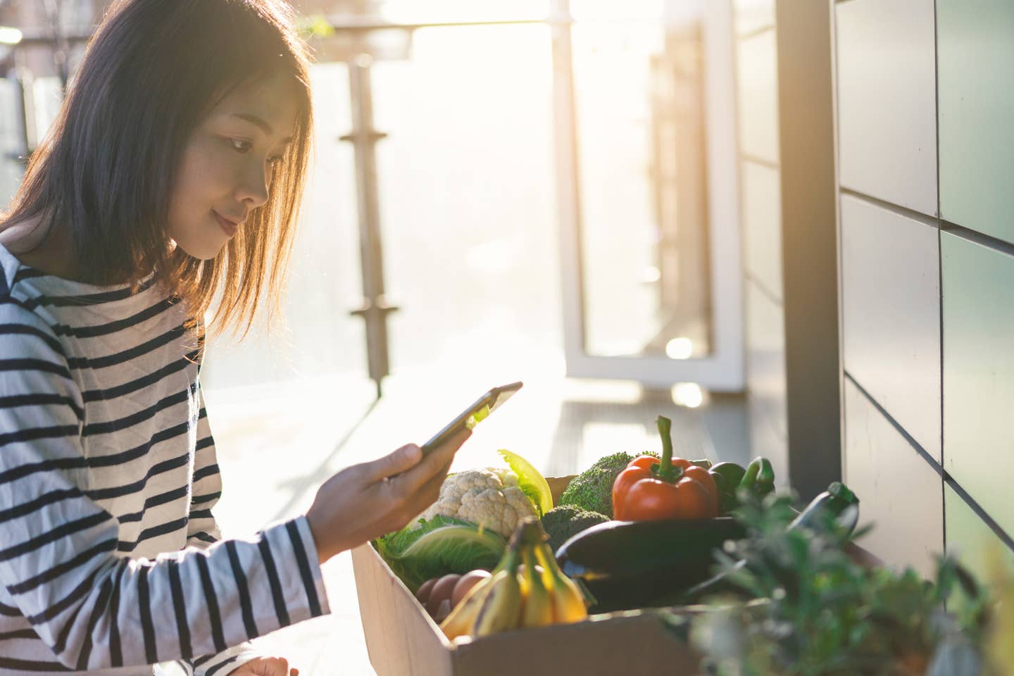 Young Woman Ordering Groceries Online with Smartphone