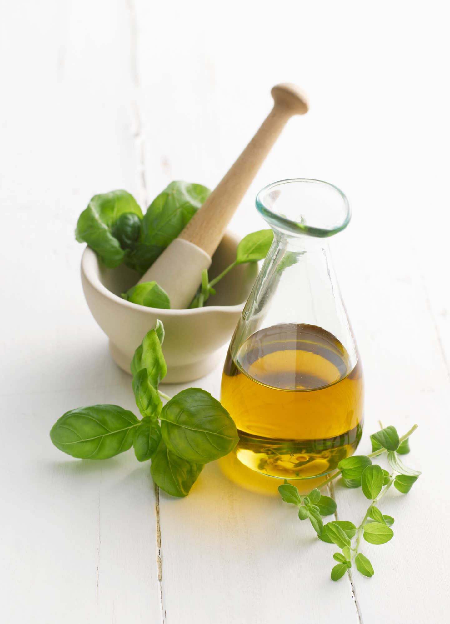 Basil and oregano leaf in mortar and pestle