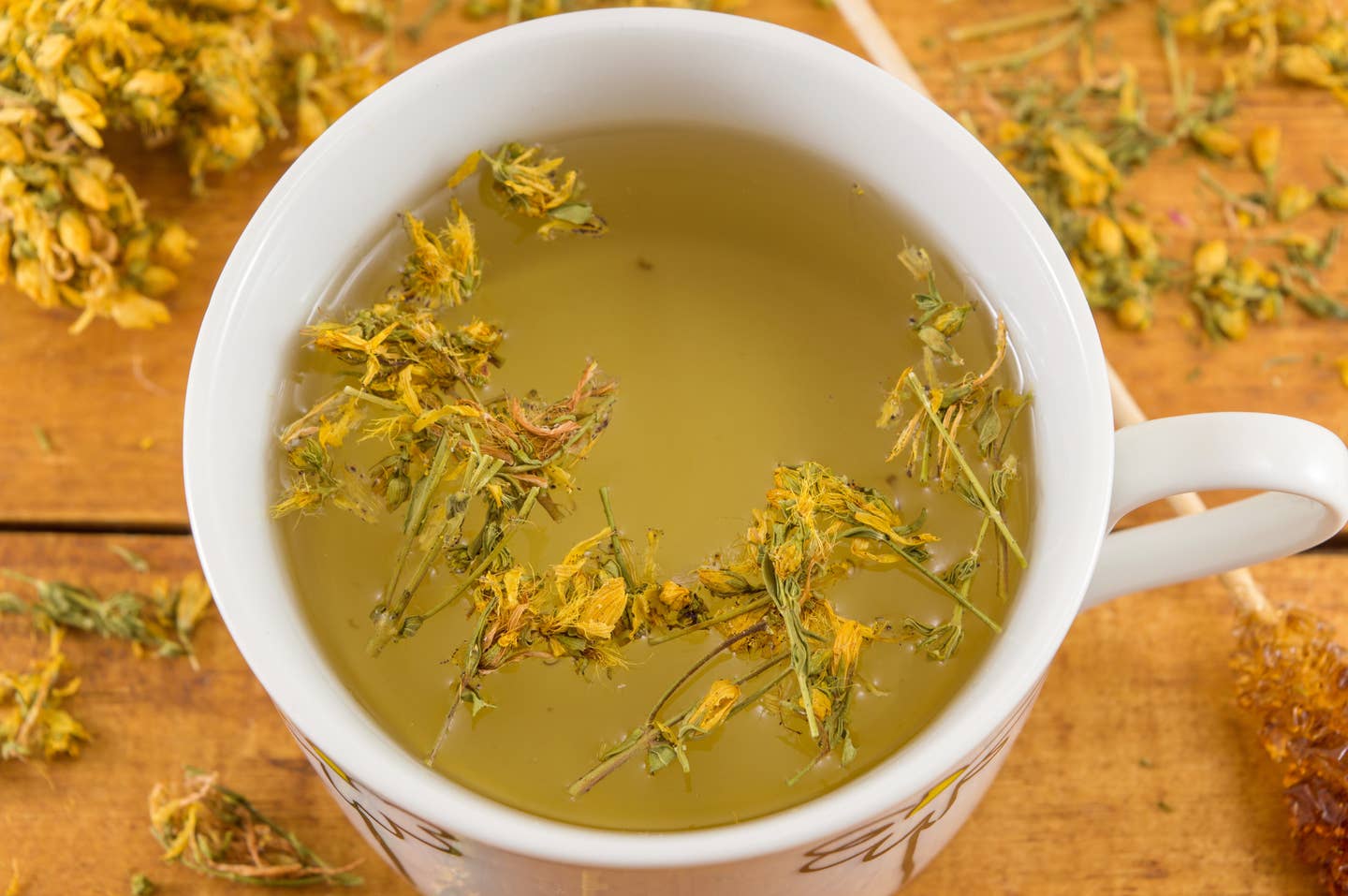 St Johns wort tea and surrounded by dried plants