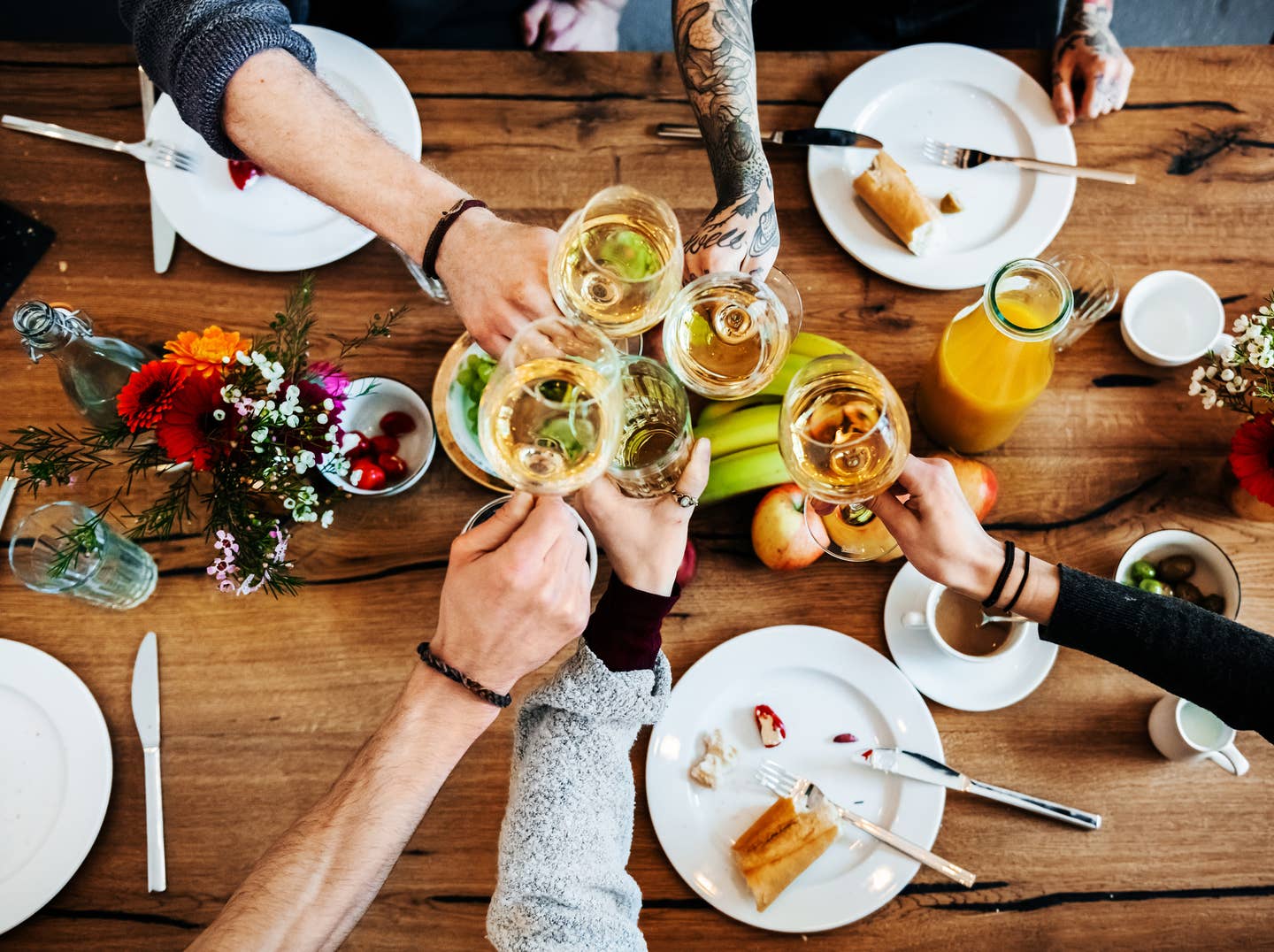 Young people having a toast with a glass of wine.