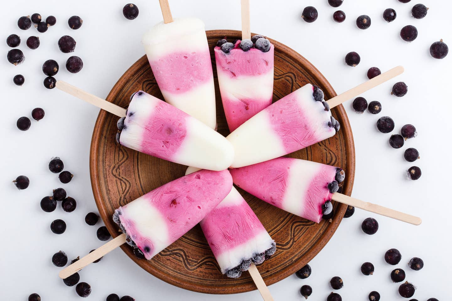 Food background.  Homemade berry yogurt ice pops with frozen black currant