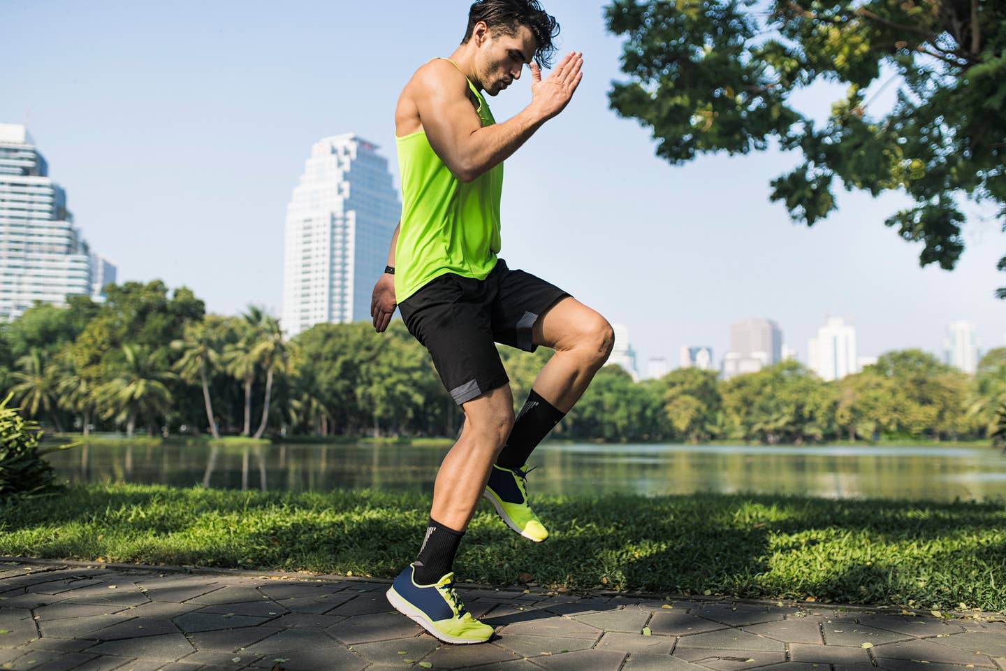 Runner warming up in urban park